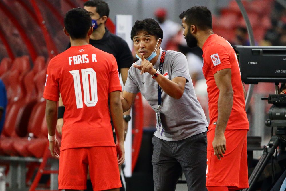 Singapore head coach, Tatsuma Yoshida (centre) gives instructions to substitutes, Faris Ramli (left) and M. Anumanthan during the match against Timor Leste at the National Stadium in Singapore December 14, 2021. u00e2u20acu201d Reuters pic