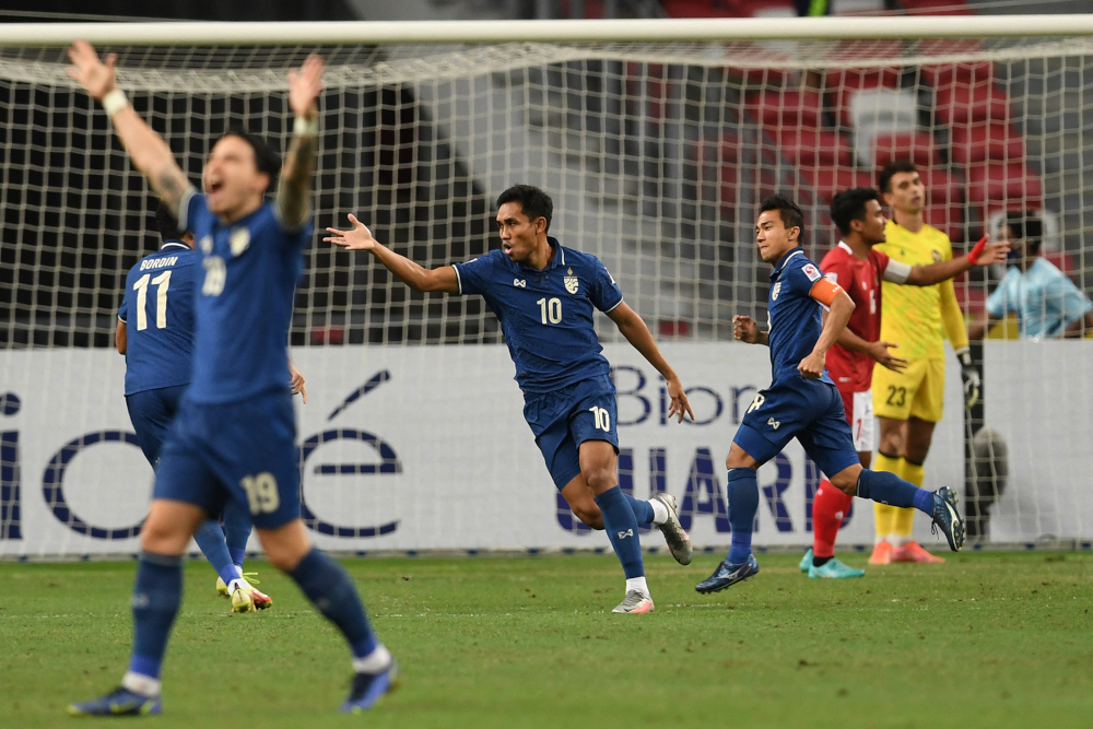 Thailandu00e2u20acu2122s Chanathip Songkrasin (3rd right) celebrates scoring during the first leg of the AFF Suzuki Cup 2020 football final match between Indonesia and Thailand at the National Stadium in Singapore, December 29, 2021. u00e2u20acu201d AFP pic 