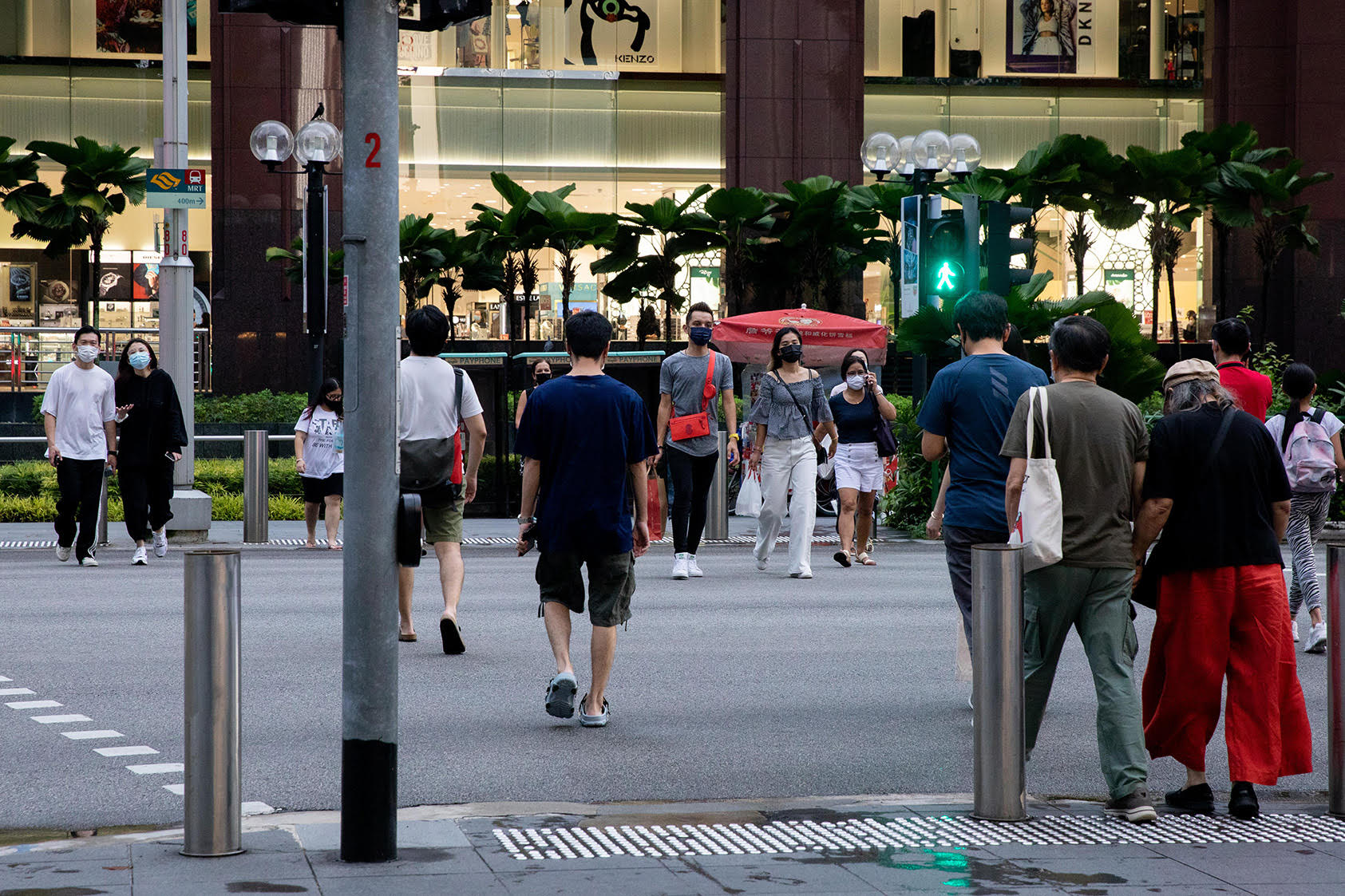 Pedestrians at a traffic crossing in front of Ngee Ann City mall along Orchard Road. u00e2u20acu2022 TODAY pic