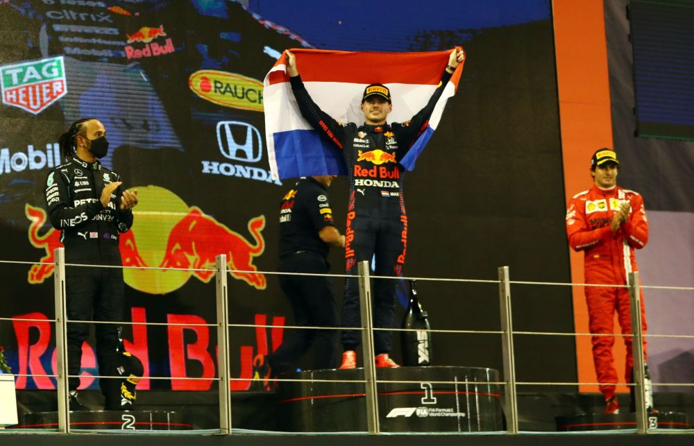 Red Bull's Max Verstappen celebrates after winning the race and the world championship on the podium at the Yas Marina Circuit, Abu Dhabi December 12, 2021. u00e2u20acu201d Reuters picnn