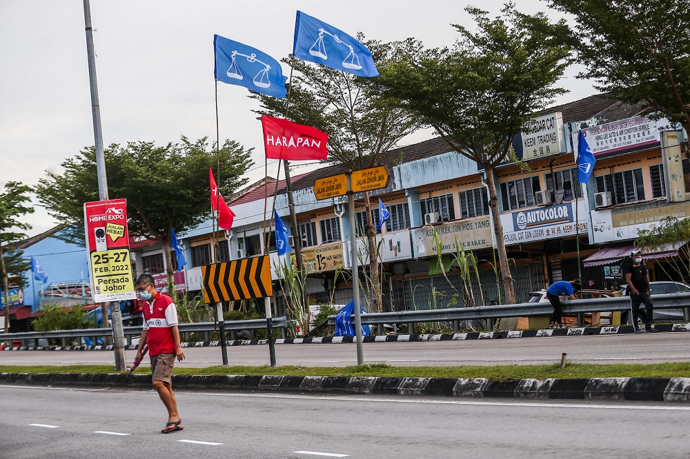 Barisan Nasional and Pakatan Harapan flags are seen along a road ahead of the Johor state election, in Johor Jaya February 28, 2022. u00e2u20acu201d Picture by Hari Anggara