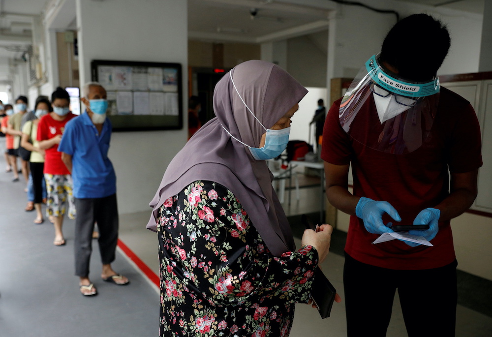 Residents of a public housing estate queue up for mandatory coronavirus disease swab tests in Singapore May 21, 2021. u00e2u20acu2022 Reuters picnn