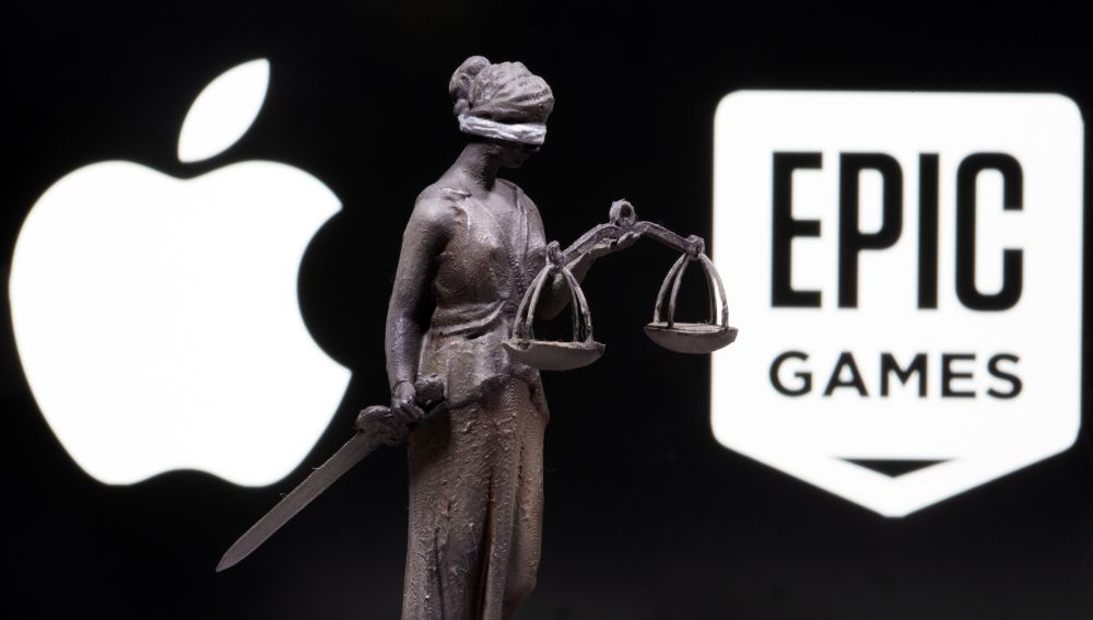 A 3D printed Lady Justice figure is seen in front of displayed Apple and Epic Games logos in this illustration photo taken February 17, 2021.u00e2u20acu201d Reuters pic