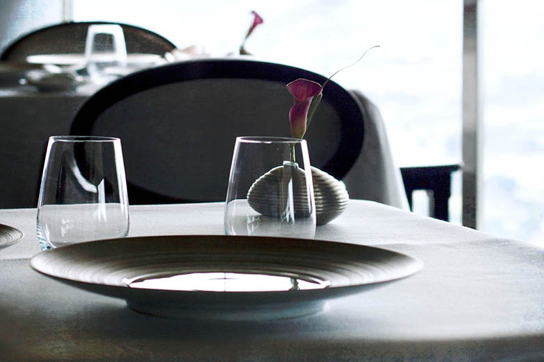 How does one explain the merits of neatly ironed, white tablecloths versus a wooden picnic table?