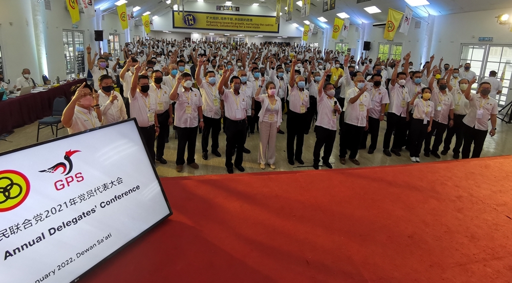 Dr Sim (eighth left, front row) leads delegates in cheering u00e2u20acu02dcSau00e2u20acu2122atiu00e2u20acu2122 during a photocall. u00e2u20acu201d Borneo Post picture