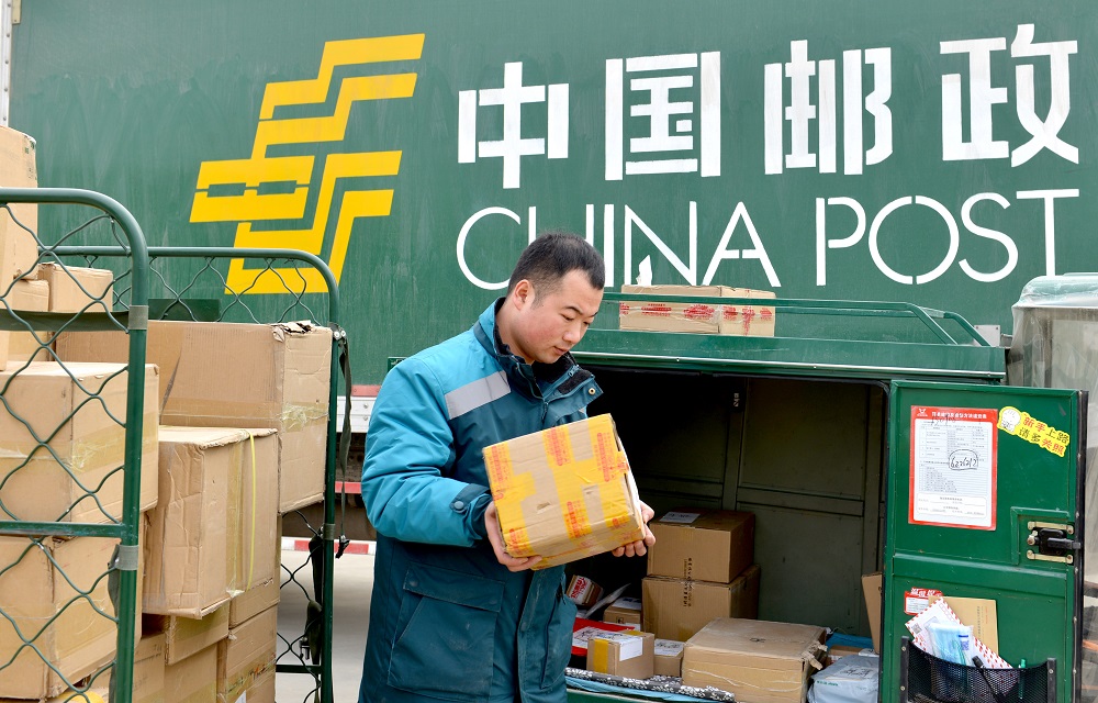 A courier unloads parcels from a truck of China Post in Xiayi county, Shangqiu city, central China's Henan province, 15 February 2018. u00e2u20acu201d Reuters file pic