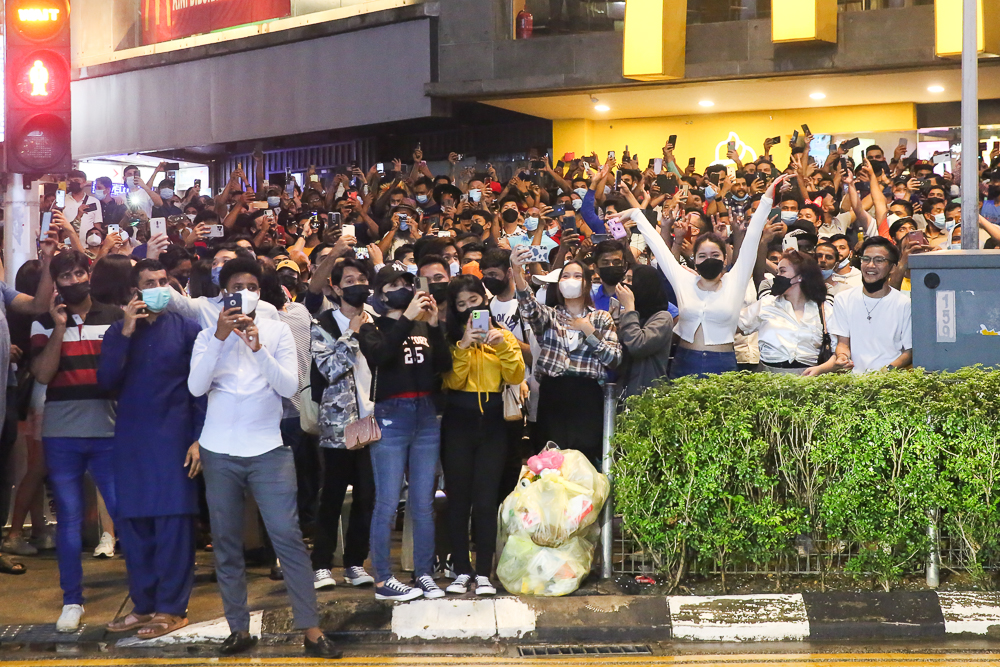 People cheer as they gather for the New Year countdown along Jalan Bukit Bintang in Kuala Lumpur December 31, 2021. 