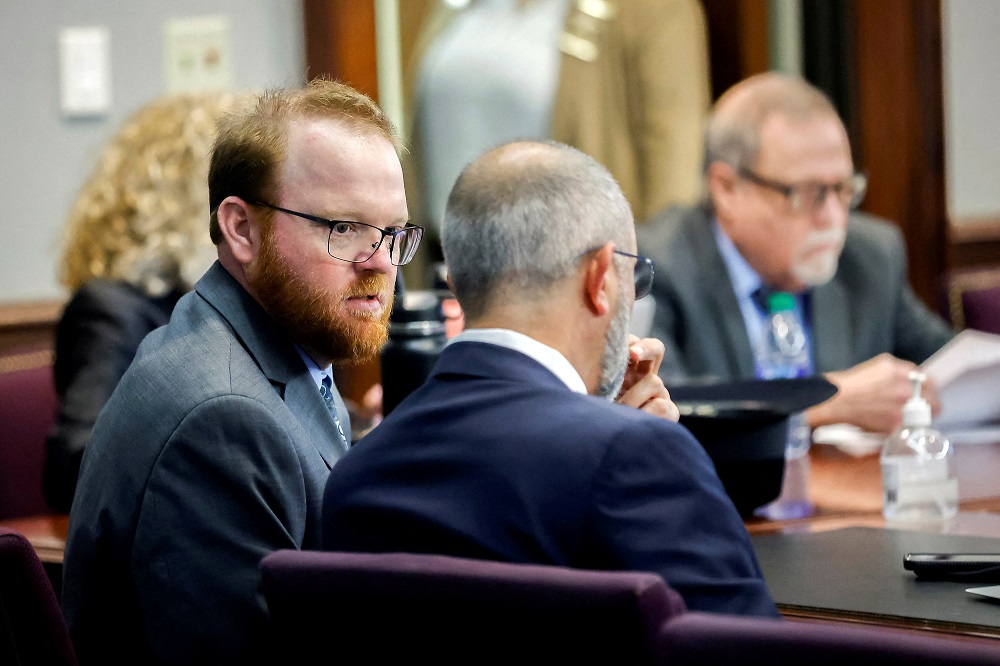 Travis McMichael (left) speaks with his attorney during the sentencing of him, his father Greg McMichael and neighbour, William u00e2u20acu02dcRoddieu00e2u20acu2122 Bryan in the Glynn County Courthouse, in Brunswick, January 7, 2022. u00e2u20acu201d Stephen B. Morton/Pool pic via Reuters