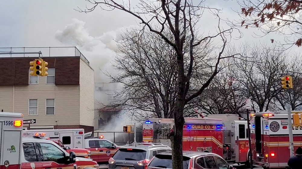 Emergency vehicles line the street as smoke raises following a fire and explosion at a building in New York January 18, 2022. u00e2u20acu201d Picture courtesy of Hector Rodriguez/via Reuters