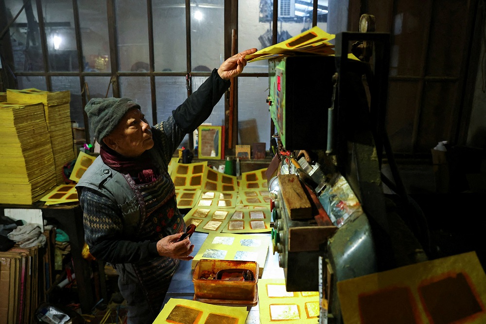 Chen Kun-huei, 82, works at his joss paper workshop which was started by his grandfather ahead of Lunar New Year in Miaoli, Taiwan January 20, 2022. u00e2u20acu201d Reuters pic