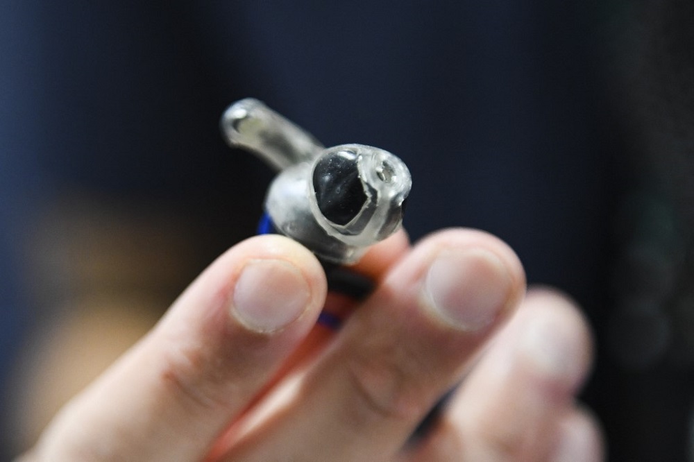 French startup Wisear cofounder Yacine Achiakh holds a pair of prototype earbuds during the Consumer Electronics Show in Las Vegas January 6, 2022. u00e2u20acu201d AFP pic