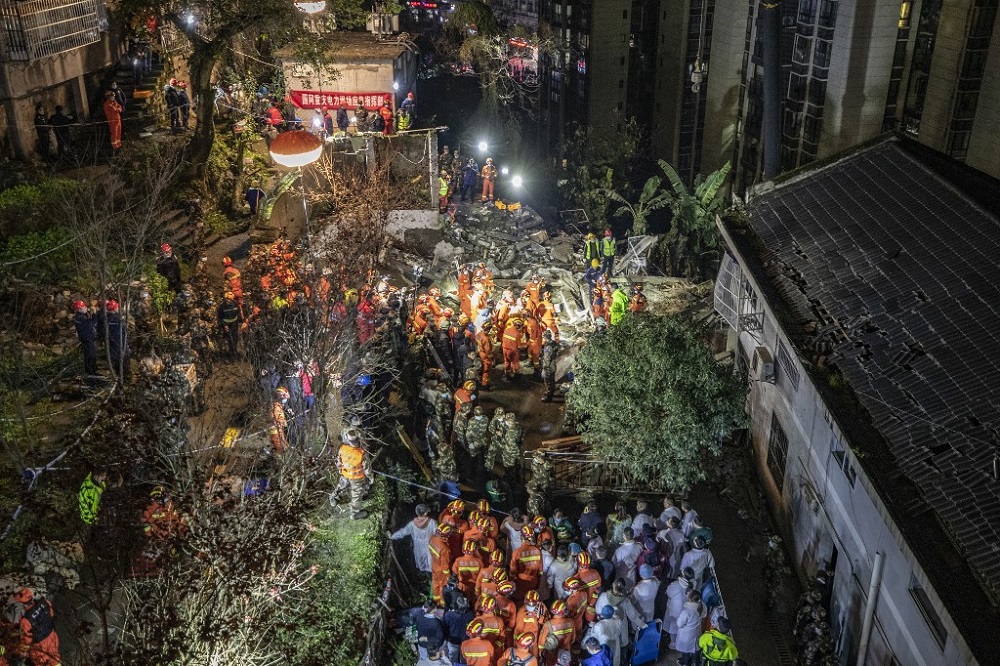 Rescuers search at the scene of an explosion that caused a building to collapse and killed at least nine people in southwestern Chinau00e2u20acu2122s city of Chongqing on January 7, 2022. u00e2u20acu201d AFP pic