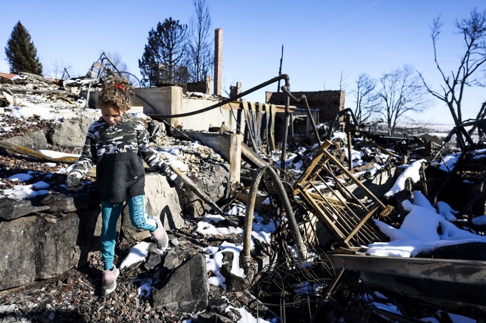 Charley Ferrera, 8, walks through what remains of her grandfather's house in a neighborhood decimated by the Marshall Fire on January 2, 2022 in Louisville, Colorado. u00e2u20acu201d AFP pic