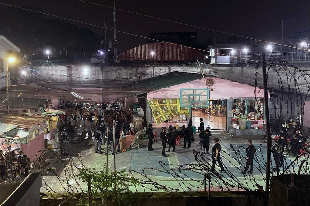 This undated handout photo shows members of the police SWAT guarding the premises after a deadly brawl between rival gangs at Caloocan City Jail, suburban Manila. u00e2u20acu201d Picture by Bureau of Jail Management and Penology u00e2u20acu201d National Capital Region via AFP 