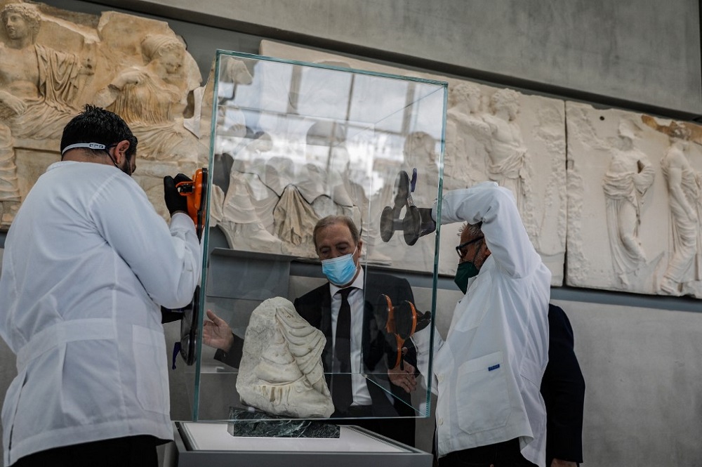 Acropolis museum staff members display a marble fragment from the Parthenon, believed to depict the foot and lower tunic of the goddess Artemis, in Athens January 10, 2022. u00e2u20acu201d AFP pic