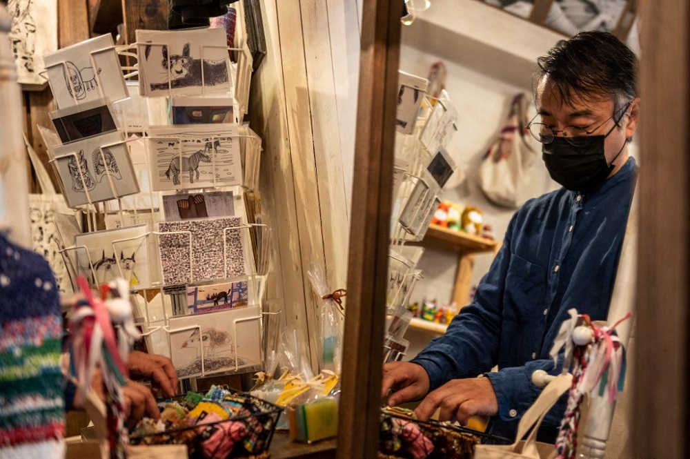 Mitsuhiro Fujimoto, an operator for Majerca, a welfare trade shop that sells items made by hand by people with various disabilities across Japan, works at a store in the Kichijoji district in Tokyou00e2u20acu2122s Musashino area October 7, 2021. u00e2u20acu201d AFP pic