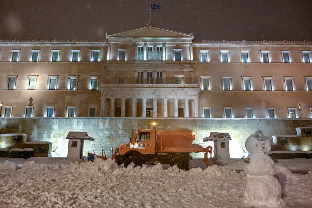 A snow plow cleans a snow-covered street in front of the Greek parliament in Athens January 24, 2022. u00e2u20acu201d AFP pic