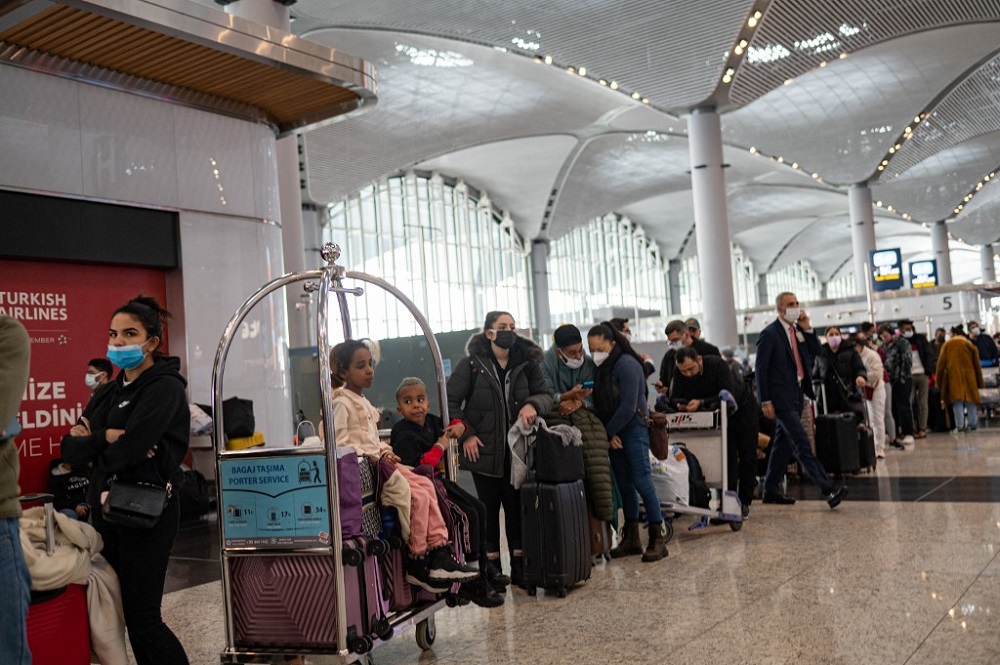 Stranded passengers wait at Istanbul airport, where flights are cancelled due to blizzard and heavy snowfall, in Istanbul January 25, 2022. — AFP pic