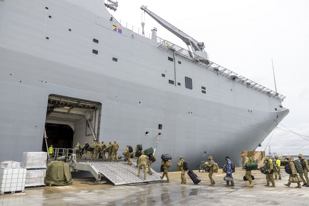 This handout photo taken and released on January 20, 2022 by the Royal Australian Air Force and the Australian Defence Force shows members of the Australian Defence Force embarking on the HMAS Adelaide at the Port of Brisbane. u00e2u20acu201d nPicture by CPL Robert W
