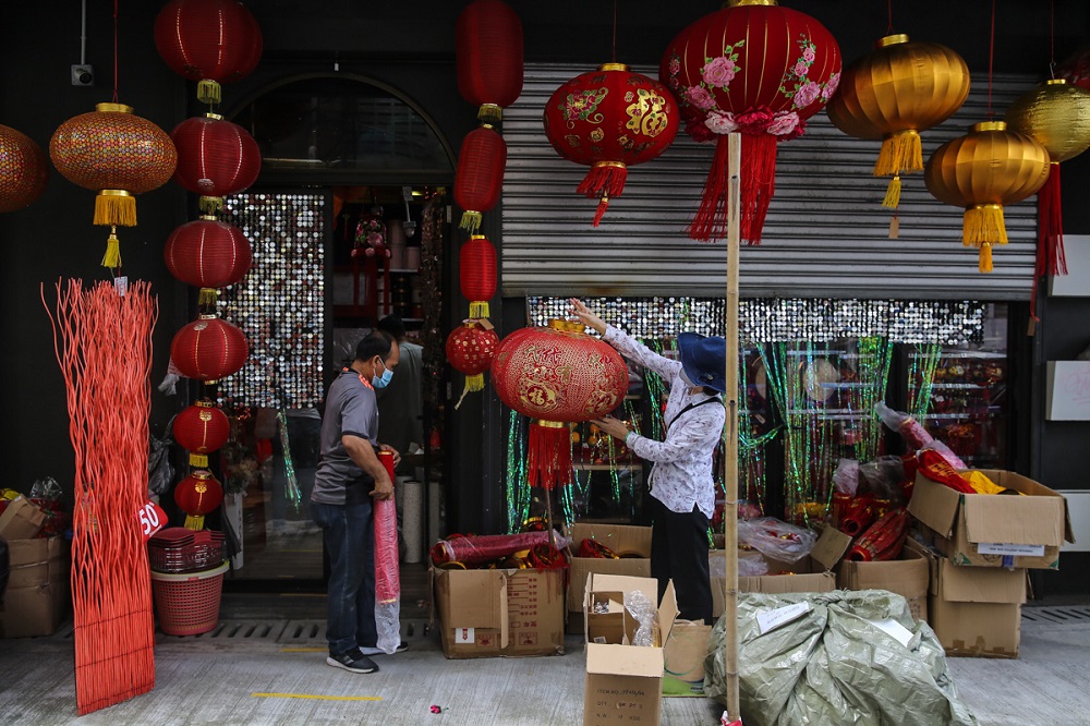 People shop for decorations ahead of the Chinese New Year celebrations at a shop situated along Petaling Street in Kuala Lumpur January 29, 2022. u00e2u20acu201d Picture by Yusof Mat Isa