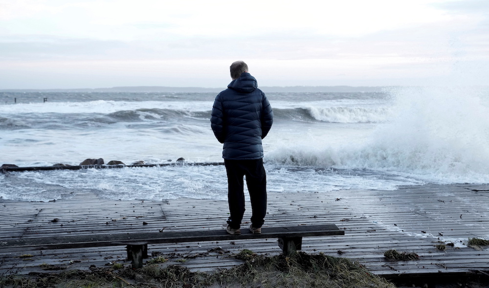 A person stands by the sea at Hornbaek Harbour, North Zealand, Denmark, January 30, 2022. u00e2u20acu201d Ritzau Scanpix/Keld Navntoft via Reuters pic