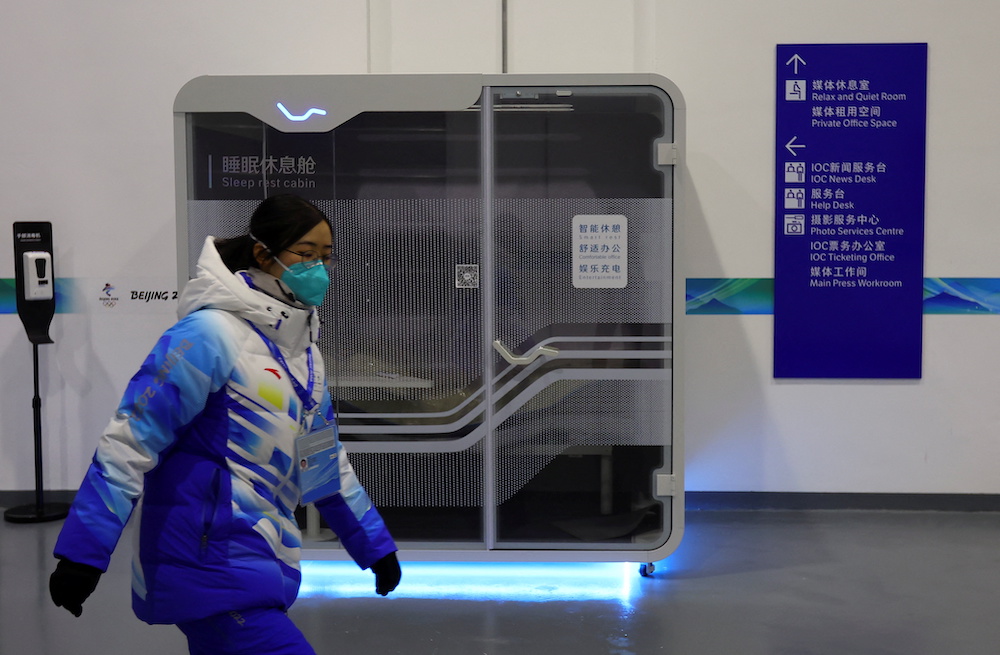 A volunteer walks in front of a sleep rest cabin at the Main Press Centre ahead of the Beijing 2022 Winter Olympics, in Beijing, China, January 10, 2022. u00e2u20acu201d Reuters pic