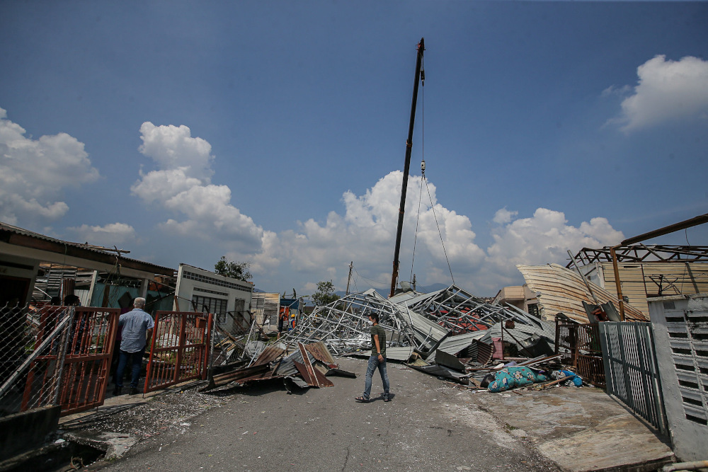 Several houses at Kampung Tawas, Ipoh were damaged or destroyed following strong winds in the area yesterday. Picture taken January 31, 2022. — Picture by Farhan Najib