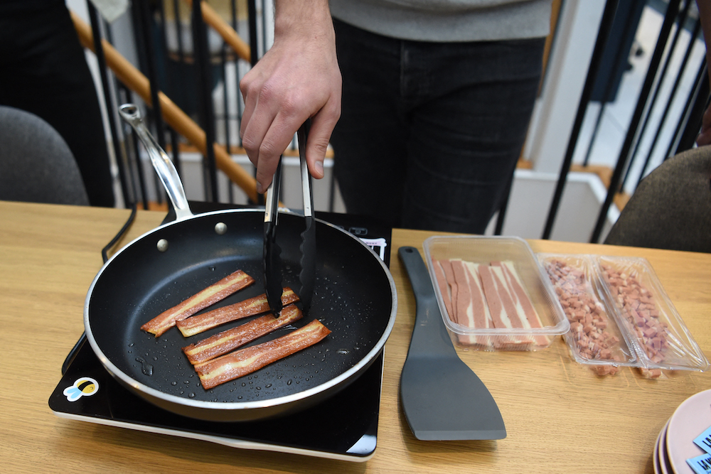 French startup u00e2u20acu02dcLa Vieu00e2u20acu2122 co-founder and CEO Nicolas Schweitzer cooks their veggie recipe bacon sticks at their headquarters in Paris on January 7, 2022. u00e2u20acu201d AFP pic