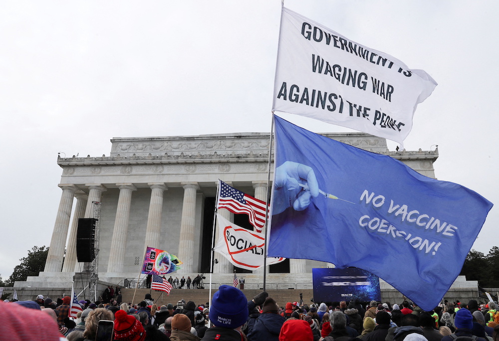 People hold flags during a rally following a march in opposition to Covid-19 mandates on the National Mall, in Washington, D.C. January 23, 2022. u00e2u20acu201d Reuters pic