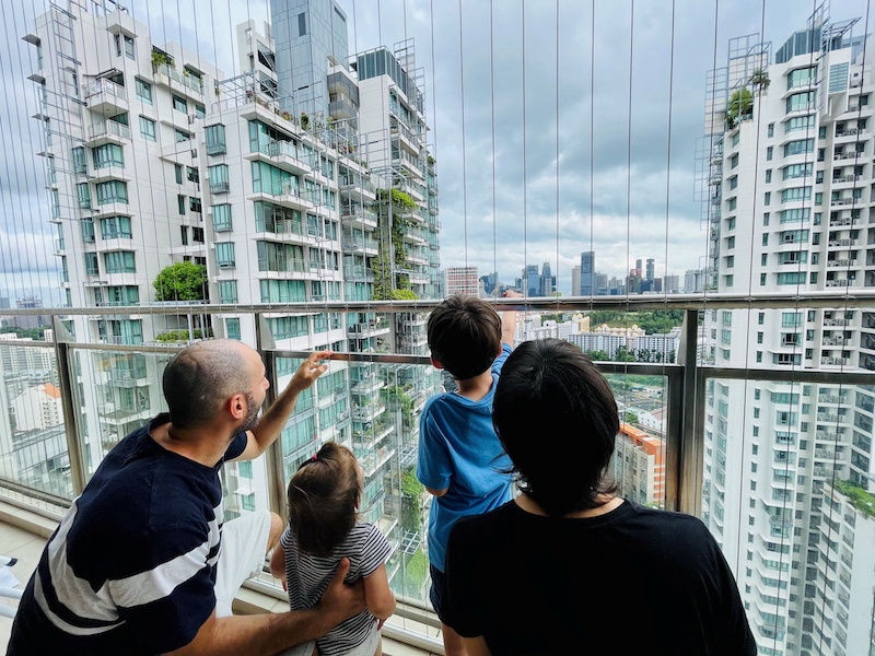 Israeli expatriate Atar Sandler, 35, and her husband speak to their children at the balcony of their apartment in central Singapore, overlooking the skyline of the South-east Asian financial hub January 8, 2022. u00e2u20acu201d Reuters pic