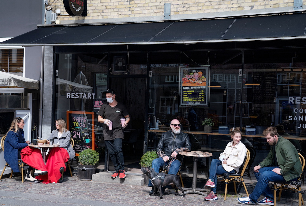 People enjoy outdoor service as cafes, bars and restaurants reopen due to Covid-19 restrictions easing in Roskilde, Denmark April 21, 2021. u00e2u20acu201d Claus Bech/Ritzau Scanpix via Reuters
