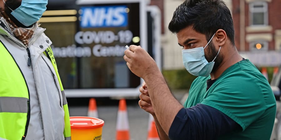 A health service worker draws up a dose of Covid-19 vaccine at a drive-through NHS (National Health Service) vaccination centre outside Ewood Park. u00e2u20acu201d AFP pic