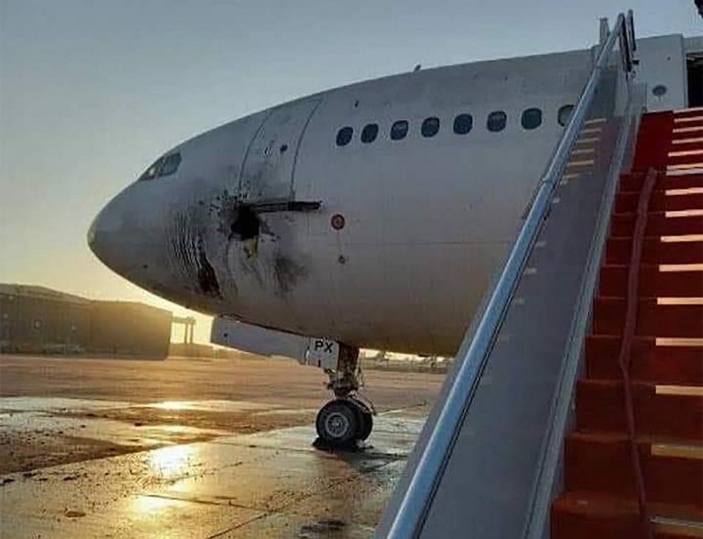A handout picture released by the Facebook page of the Iraqi ministry of transportation, shows a damaged stationary aircraft on the tarmac of Baghdad airport, after rockets reportedly tragetted the runway, on January 28, 2022. u00e2u20acu201d AFP picnn