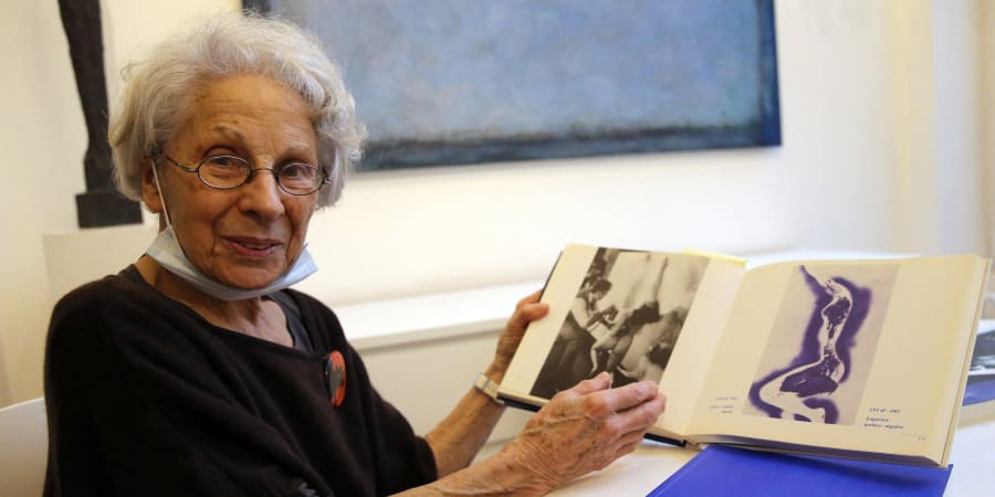 Italian Elena Palumbo-Mosca poses with Yves Klein's book during an interview in Brussels. u00e2u20acu201d ETX Studio pic