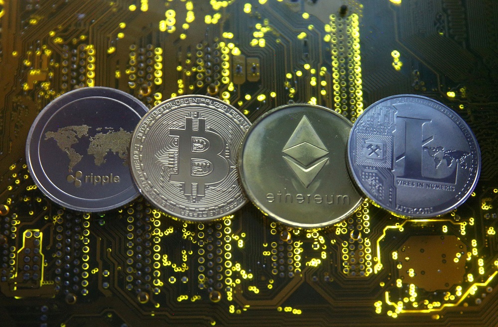 Representations of the Ripple, Bitcoin, Etherum and Litecoin virtual currencies are seen on a PC motherboard in this illustration picture, February 14, 2018. u00e2u20acu2022 Reuters file pic