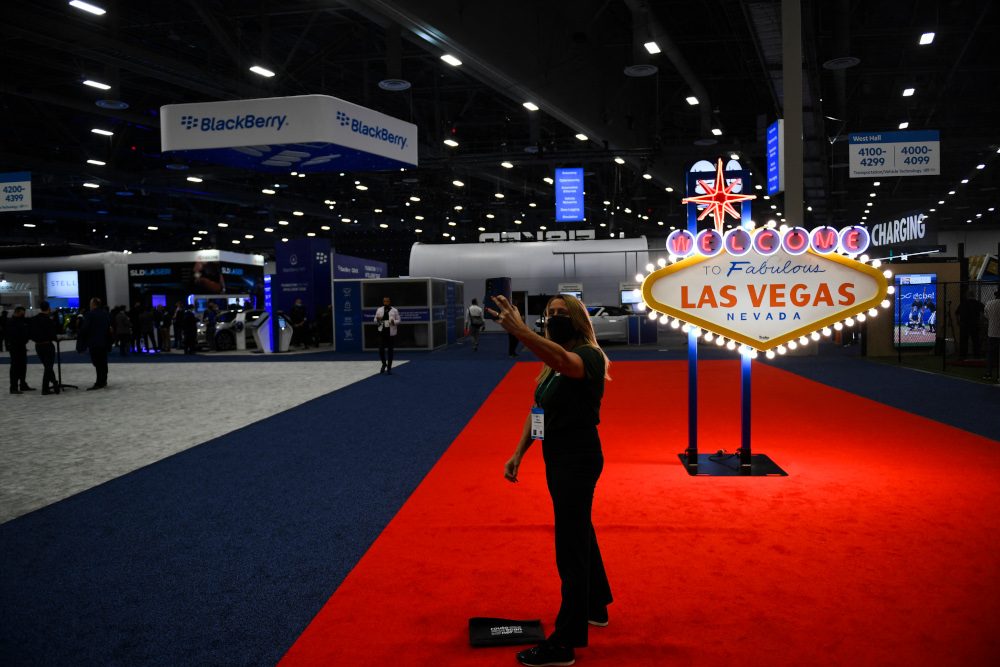 An attendee wears a face mask while taking a selfie in front of the Welcome To Fabulous Las Vegas sign on the show floor during the Consumer Electronics Show (CES) January 6, 2022 in Las Vegas, Nevada. u00e2u20acu201d AFP Pic 