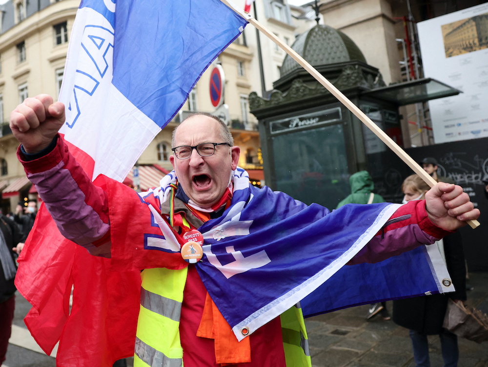 A demonstrator gestures during a demonstration to protest against a bill that would transform Franceu00e2u20acu2122s current Covid-19 health pass into a u00e2u20acu02dcvaccine passu00e2u20acu2122, in Paris, France, January 8, 2022. u00e2u20acu201d Reuters picnnn