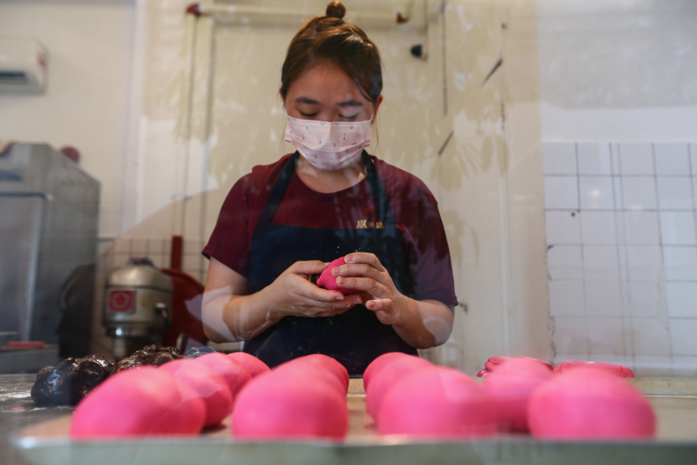 Making pastries by hand is still part of the process at Fung Wong. — Picture by Ahmad Zamzahuri