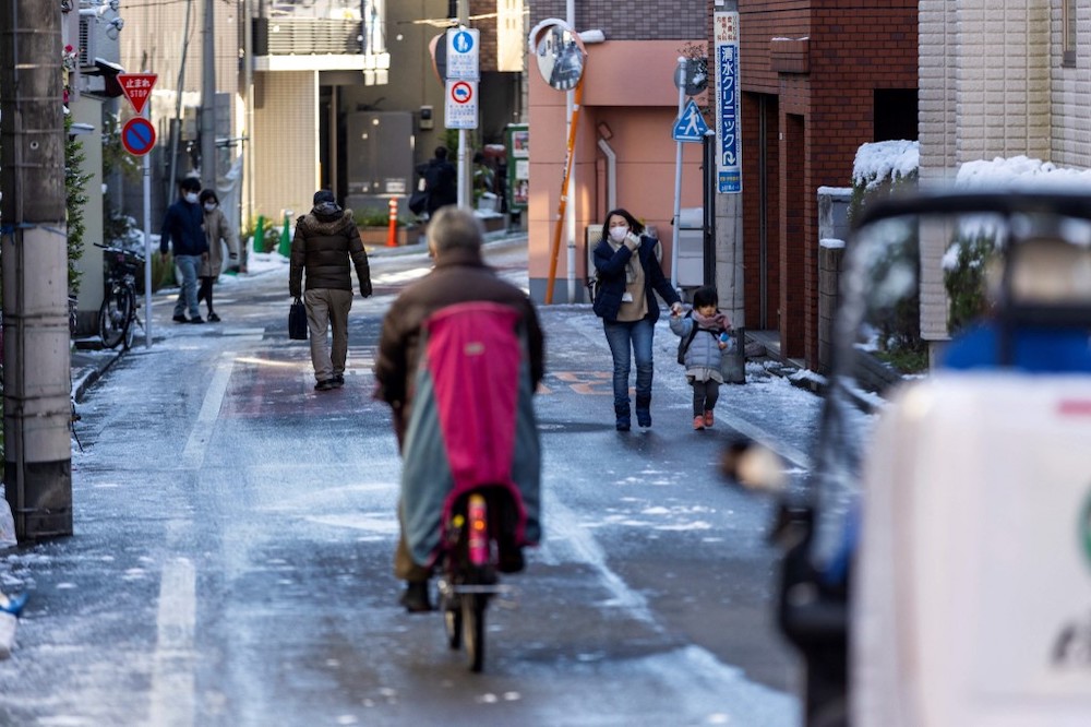 People commute on a snow ice-covered street, a day after a heavy snow in Tokyo on January 7, 2022. u00e2u20acu201d AFP pic