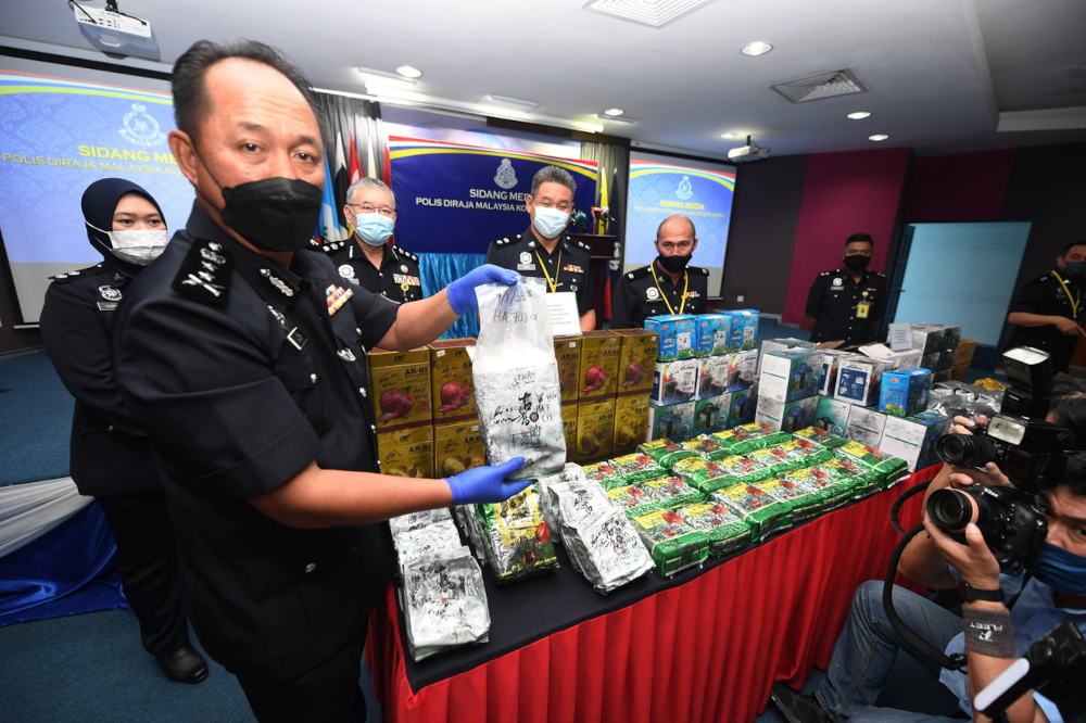 Sabah Deputy Police Commissioner Datuk Jauteh Dikun shows the drugs seized at a press conference at the Sabah contingent police headquarters in Kota Kinabalu, January 12, 2022. u00e2u20acu201d Bernama pic 