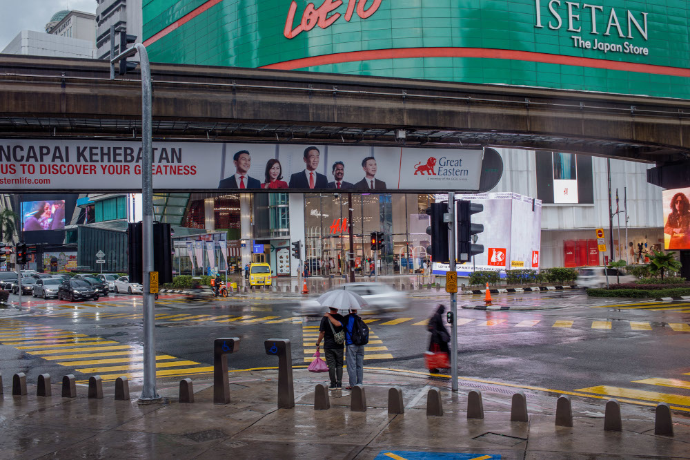 Pedestrians holding umbrellas during rainy weather in Bukit Bintang, Kuala Lumpur January 4, 2021. u00e2u20acu201d Picture by Shafwan Zaidon