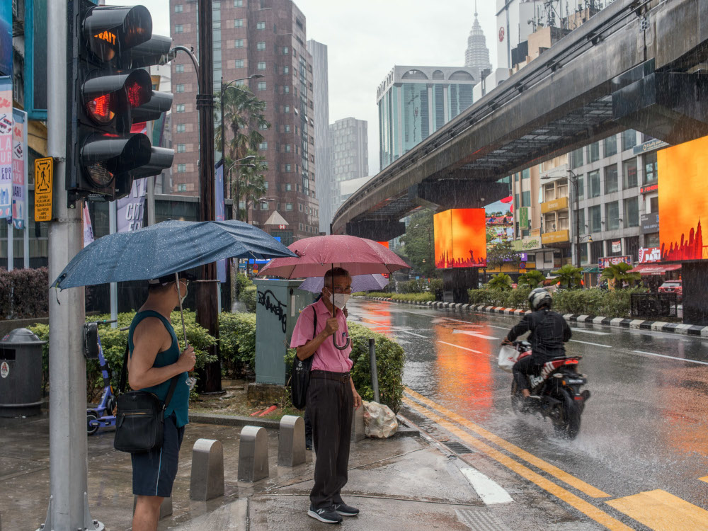 Pedestrians holding umbrellas during rainy weather in Bukit Bintang, Kuala Lumpur January 4, 2021. u00e2u20acu201d Picture by Shafwan Zaidon