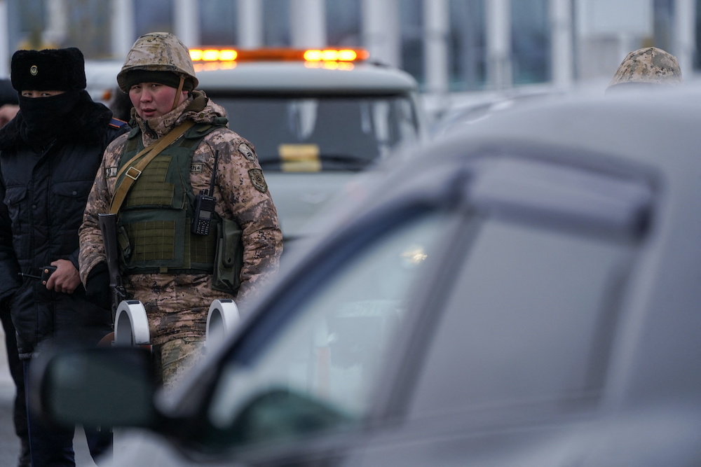 Kazakh law enforcement officers stand guard at a checkpoint, after mass protests triggered by fuel price increase erupted all over the country, in Nur-Sultan, Kazakhstan January 7, 2022. u00e2u20acu201d Reuters picnn