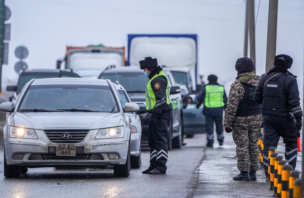 Kazakh law enforcement officers stand guard at a checkpoint on a road, after mass protests triggered by fuel price increase erupted all over the country, in Nur-Sultan, Kazakhstan January 7, 2022. u00e2u20acu201d Reuters picnn