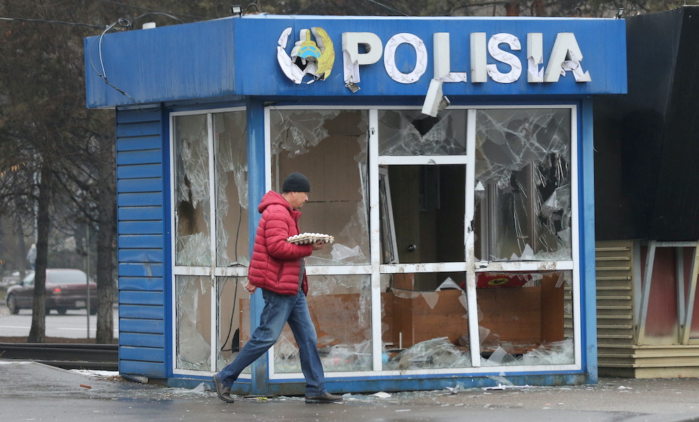 A man walks past a police station, which was vandalized during mass protests triggered by fuel price increase, in Almaty, Kazakhstan January 8, 2022. u00e2u20acu201d Reuters pic