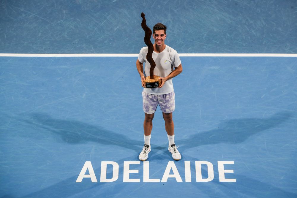 Thanasi Kokkinakis of Australia celebrates victory with the trophy after the match against Arthur Rinderknech of France during the Adelaide International 2 Mens final January 15, 2022. u00e2u20acu201d Reuters picnn