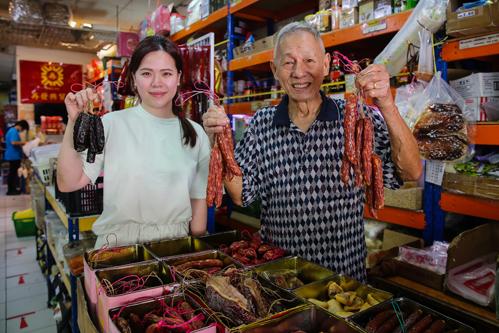 You can get recommendations from Uncle Ling (right) for your waxed meats at Chai Huat Hin while Lana Ng (left) runs the online business where you can order the waxed meats to be delivered to your doorstep. — Picture by Yusof Mat Isa