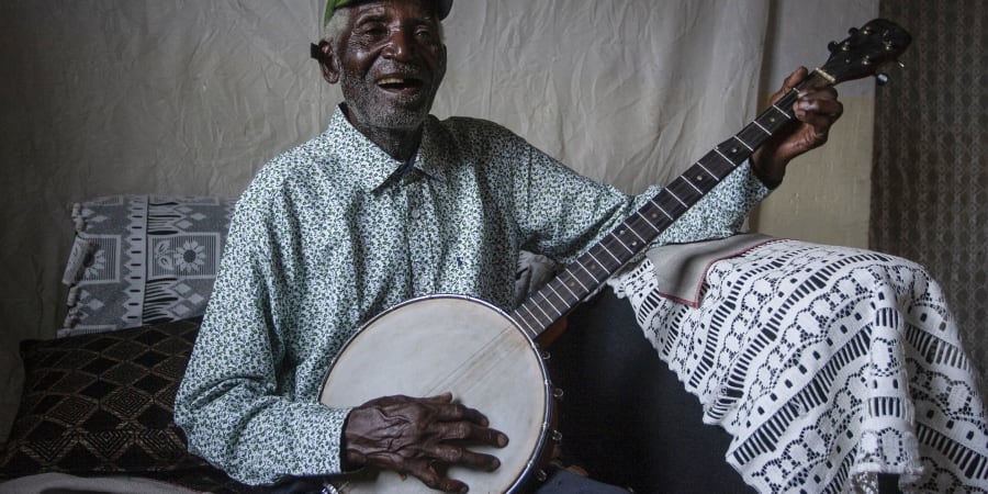 Malawian musician Giddes Chalamanda, 92, plays his acoustic Banjo at his home in the Madzuwa Village near Chiradzulu, southern Malawi. ― ETX Studio pic