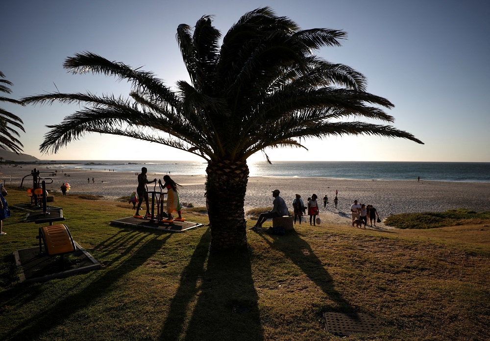 Visitors take in the sunlight at Camps Bay beach in Cape Town, South Africa, December 23, 2021. u00e2u20acu2022 Reuters file pic