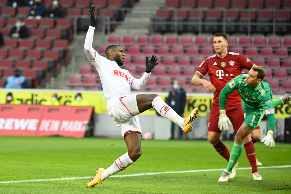 Cologne forward Anthony Modeste shoots but fails to score against Bayern Munich defender Niklas Sule and goalkeeper Manuel Neuer during the German first division Bundesliga football match in Cologne, western Germany, January 15, 2022. u00e2u20acu201d AFP picnn